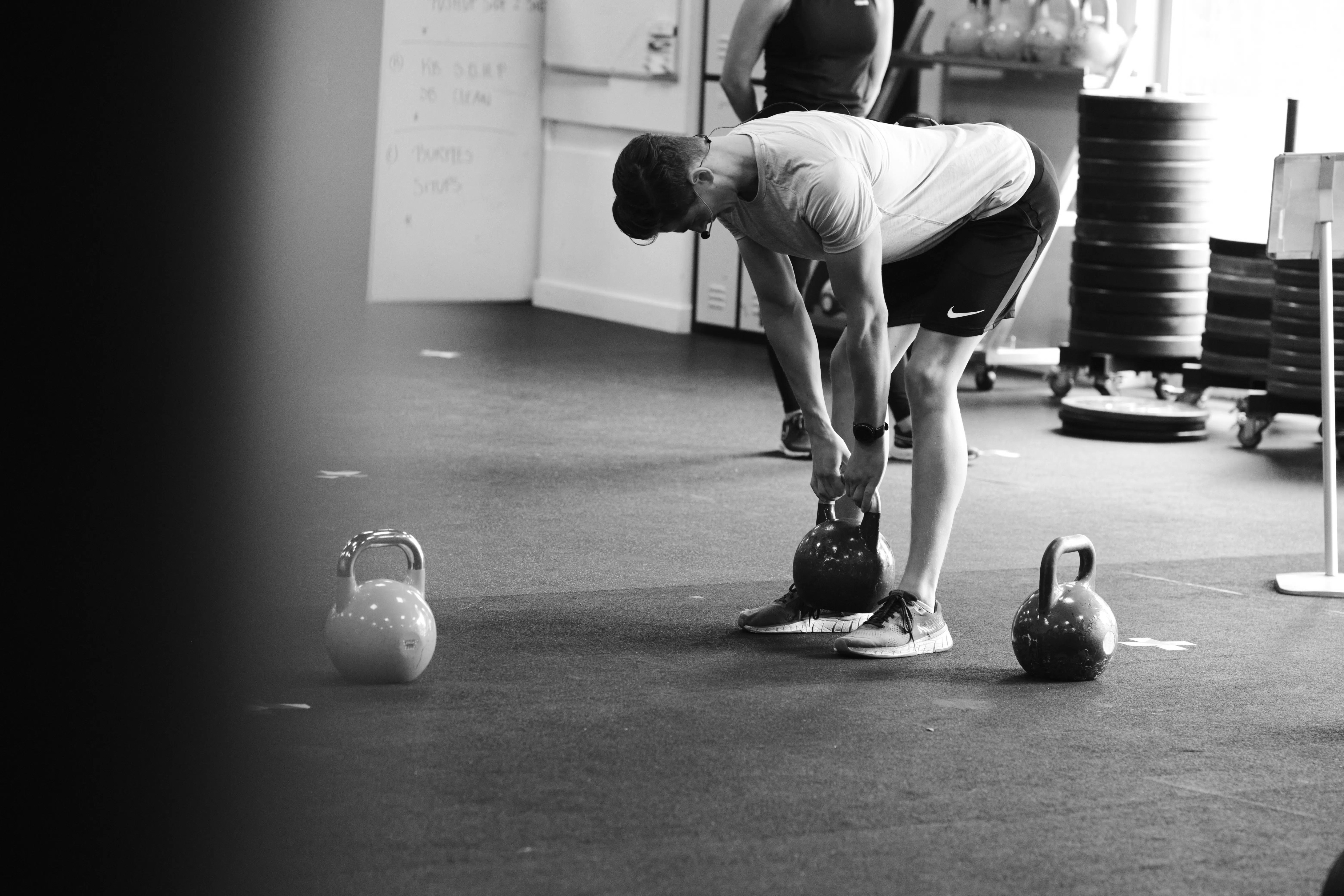 kettlebell deadlift exercise performed by a fit young guy